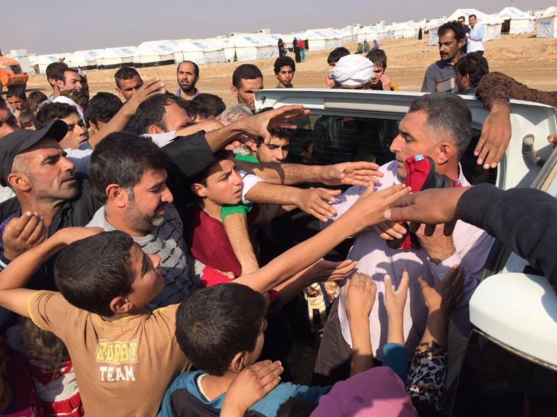 Handing out shoes at Khazir IDP camp