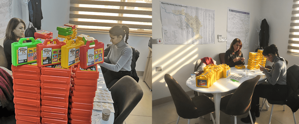 Two female volunteers preparing Christmas gifts sat in the Mosaic Middle East office, Erbil.